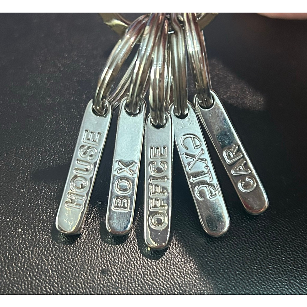 Exte brand silver tone key ring with 5 labeled removable rings